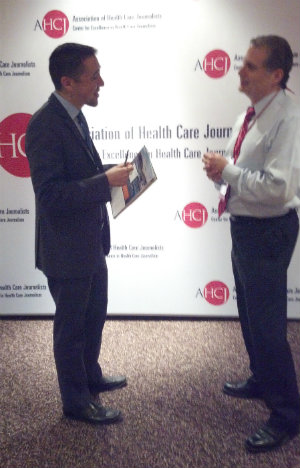 Marcus Escobedo, left, talks with AHCJ Executive Director Len Bruzzese at this year's conference in Denver.